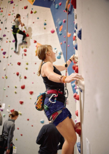 Girl-climbing-auto-belay-safety-climbing